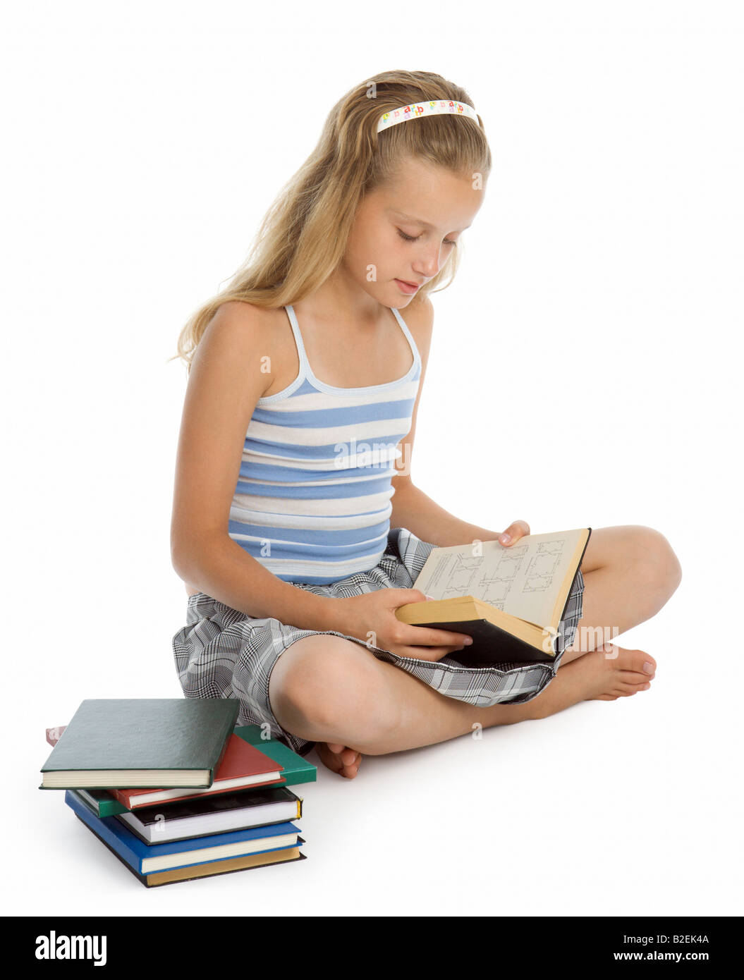 Pretty teenager girl sit on floor and reading book Stock Photo