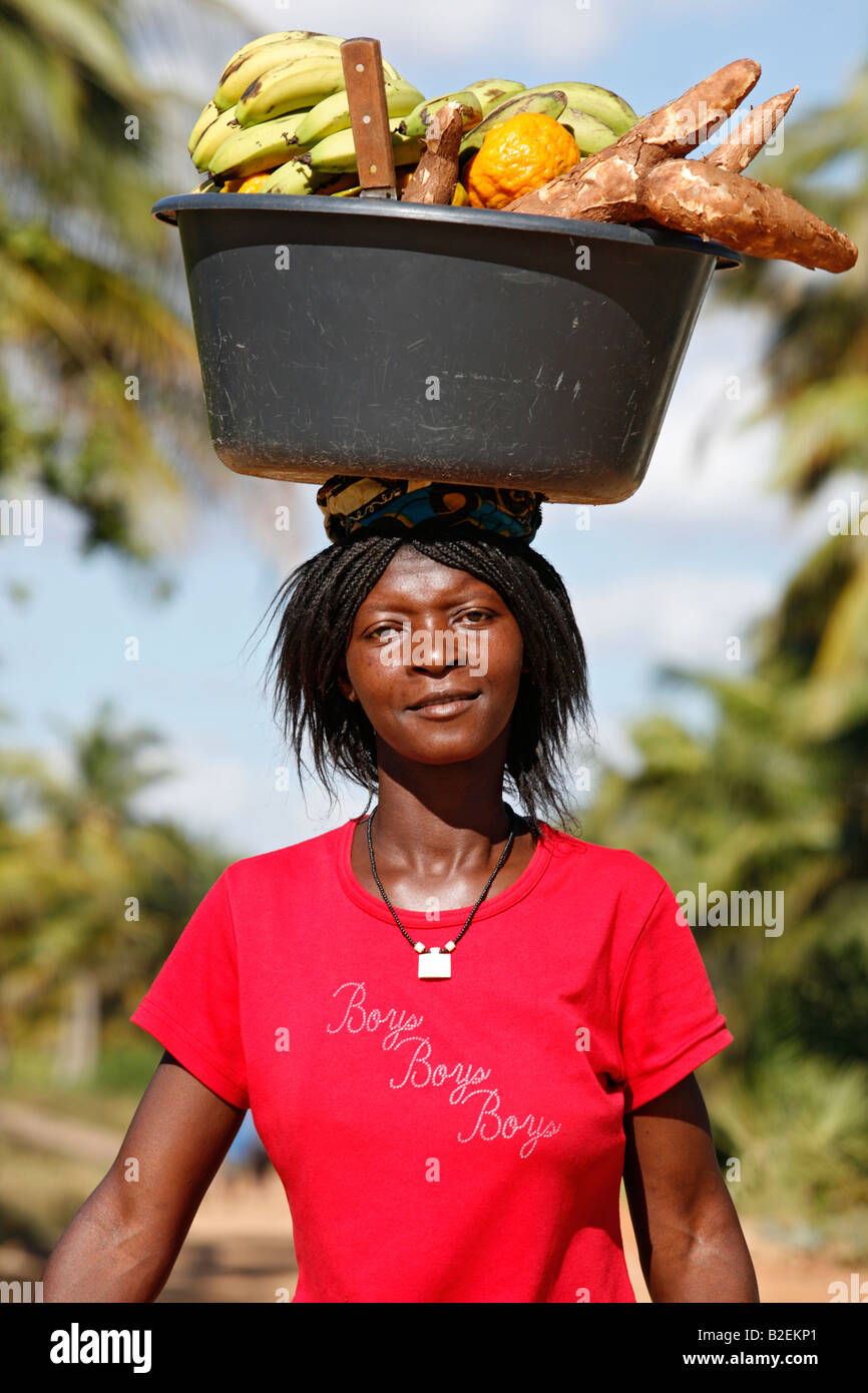 A woman balancing a black plastic bowl 