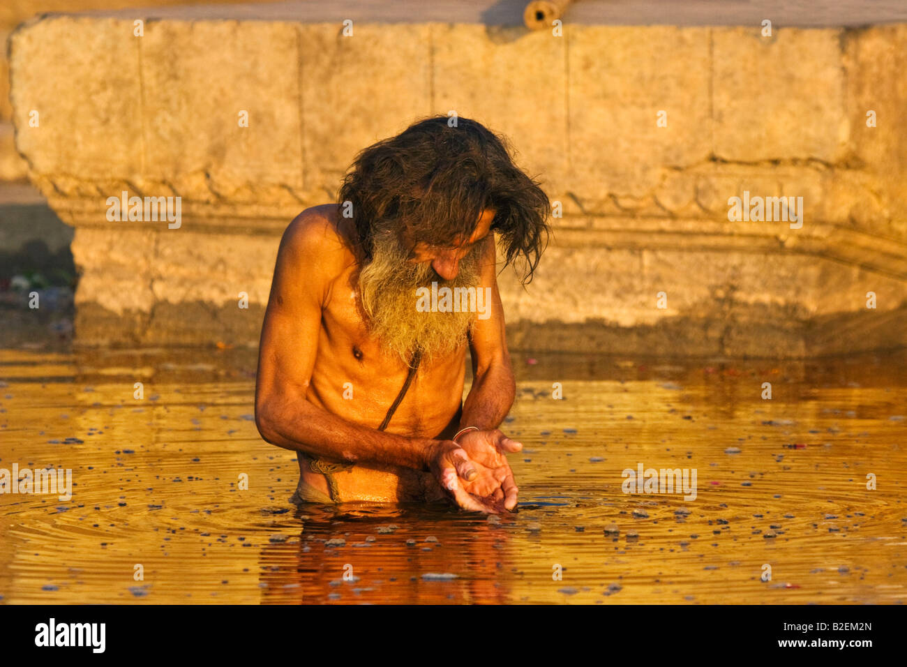 Man bathing in the river Ganges at Varanasi India Stock Photo