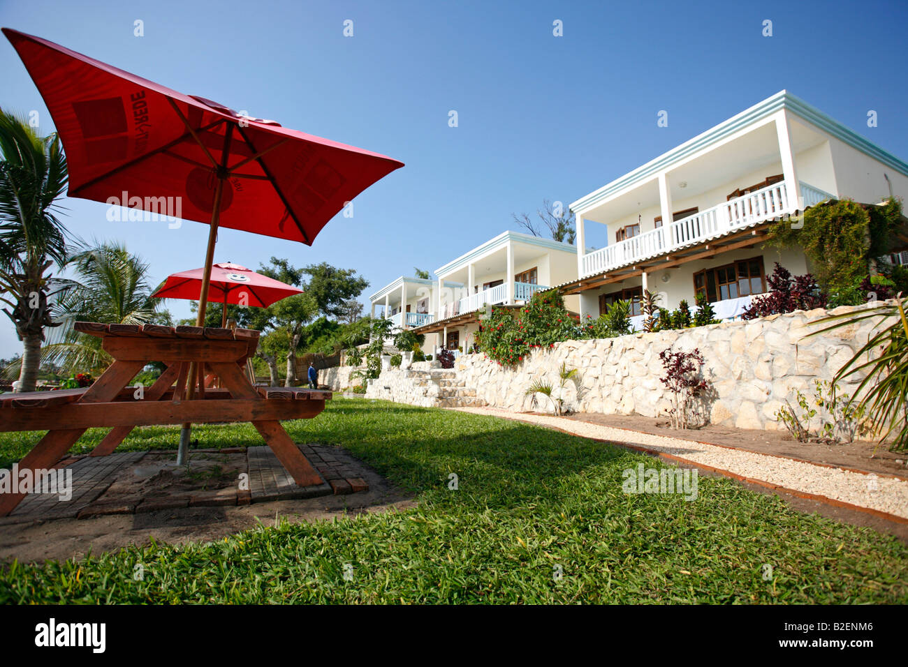 Wooden table, umbrella and tourist chalets in a seaside resort in Vilanculos Stock Photo