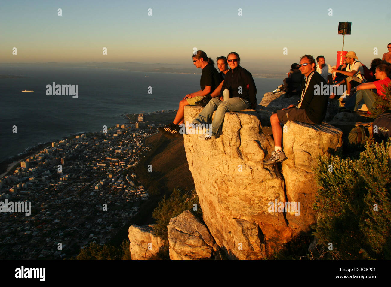 Crowd of people at the summit of Lions Head at sunset awaiting the full moon Stock Photo