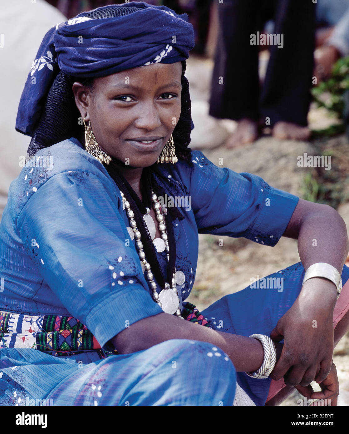 A woman at Senbete market wears old silver and brass jewellery. Her two pendants are made from Maria Theresa thalers. Stock Photo