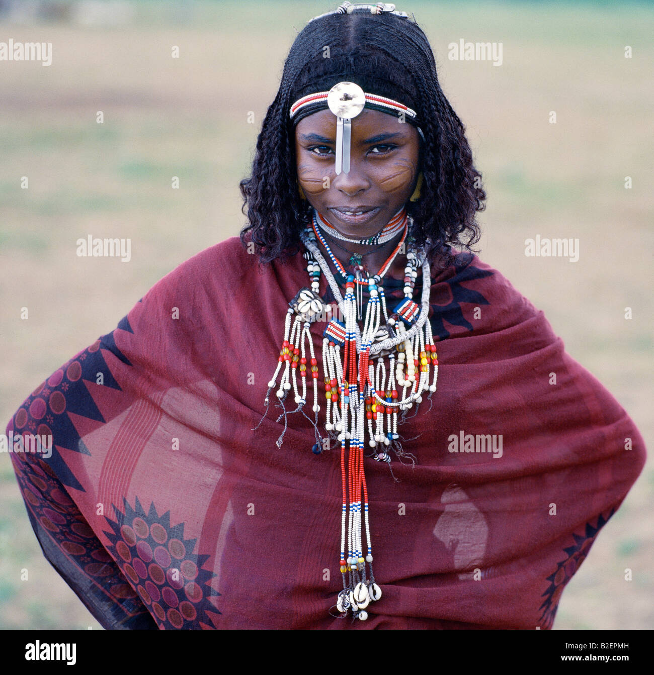 An Afar girl with braided hair has very noticeable scarification on her