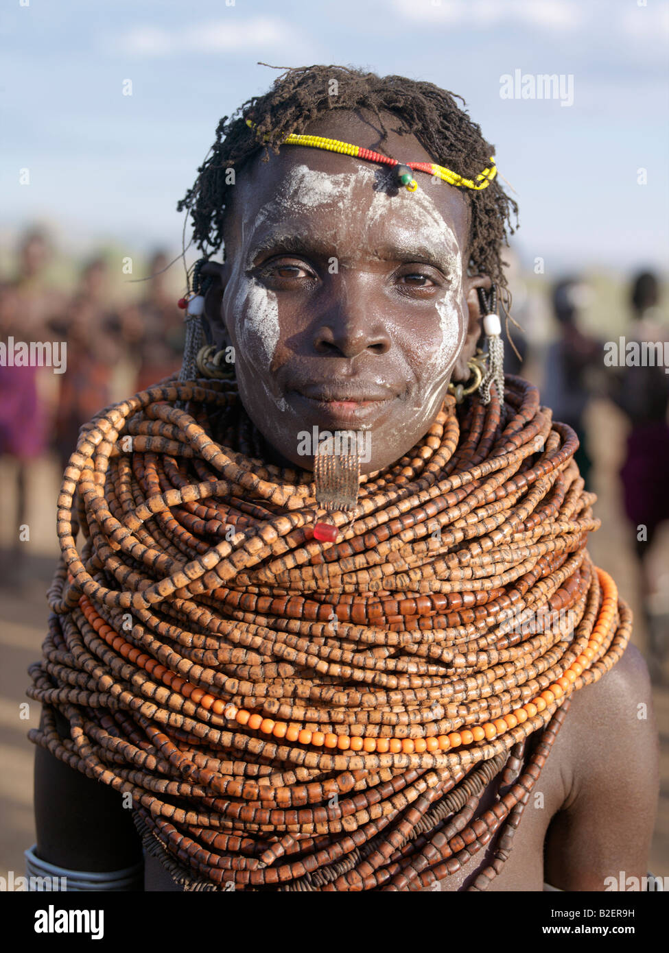 A Nyag'atom woman, her face painted in readiness for a dance, wears a lip ornament in the hole pierced below her lower lip. Stock Photo
