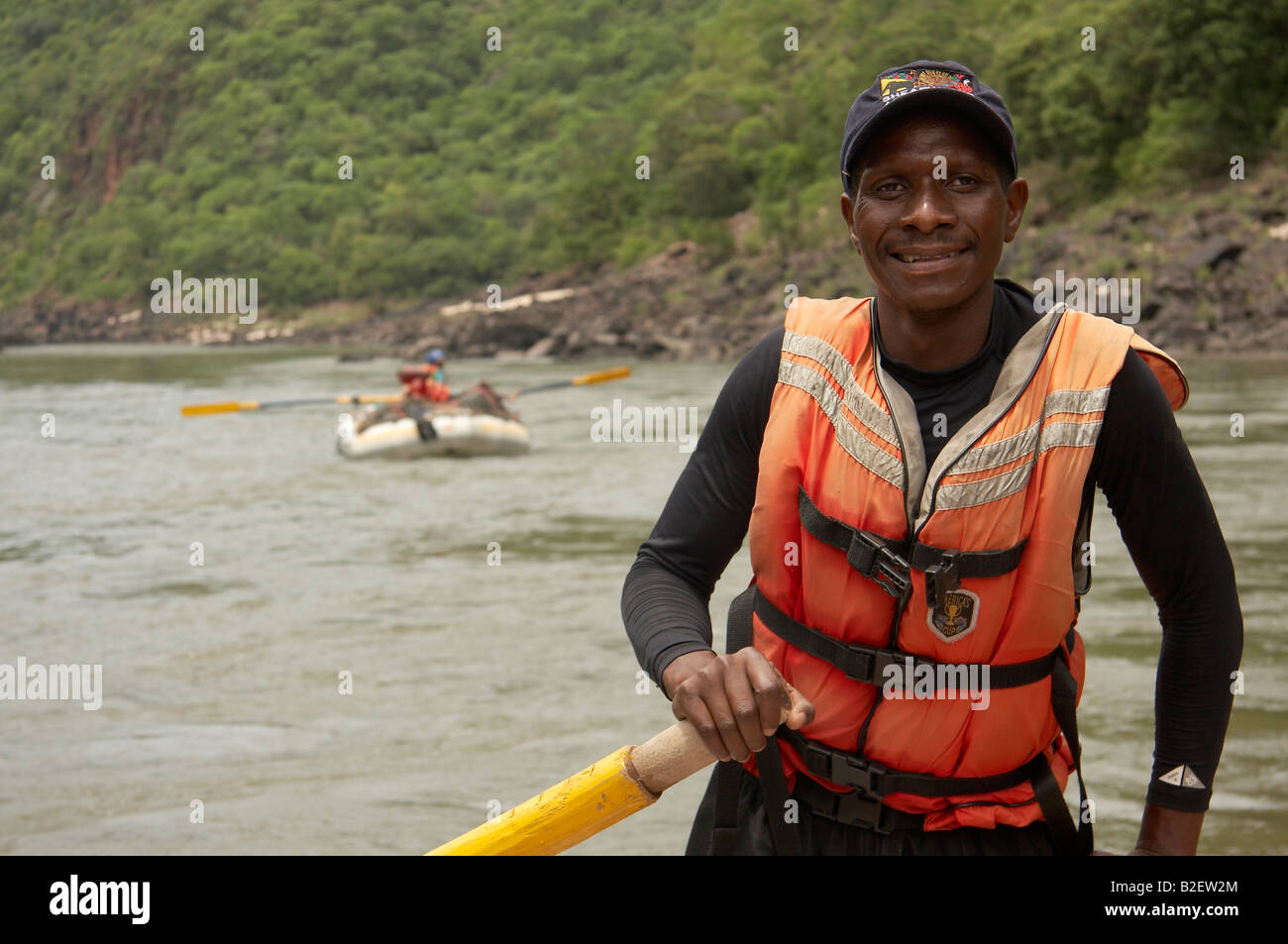 Rafter responsible for raft containing supplies and equipment on white water rafting expedition on the Zambezi Stock Photo