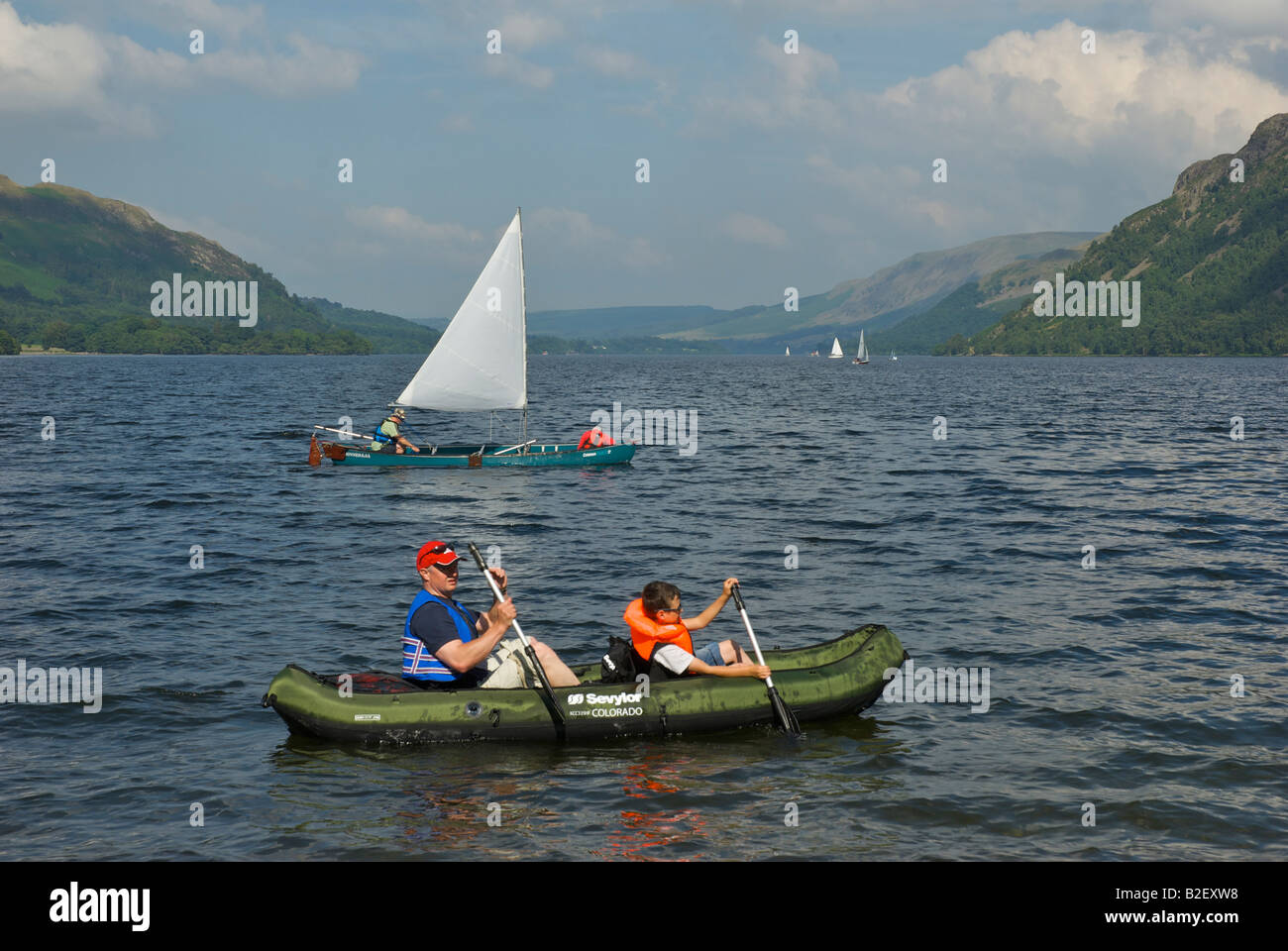 Two canoes one equipped with sail on Ullswater, Lake District