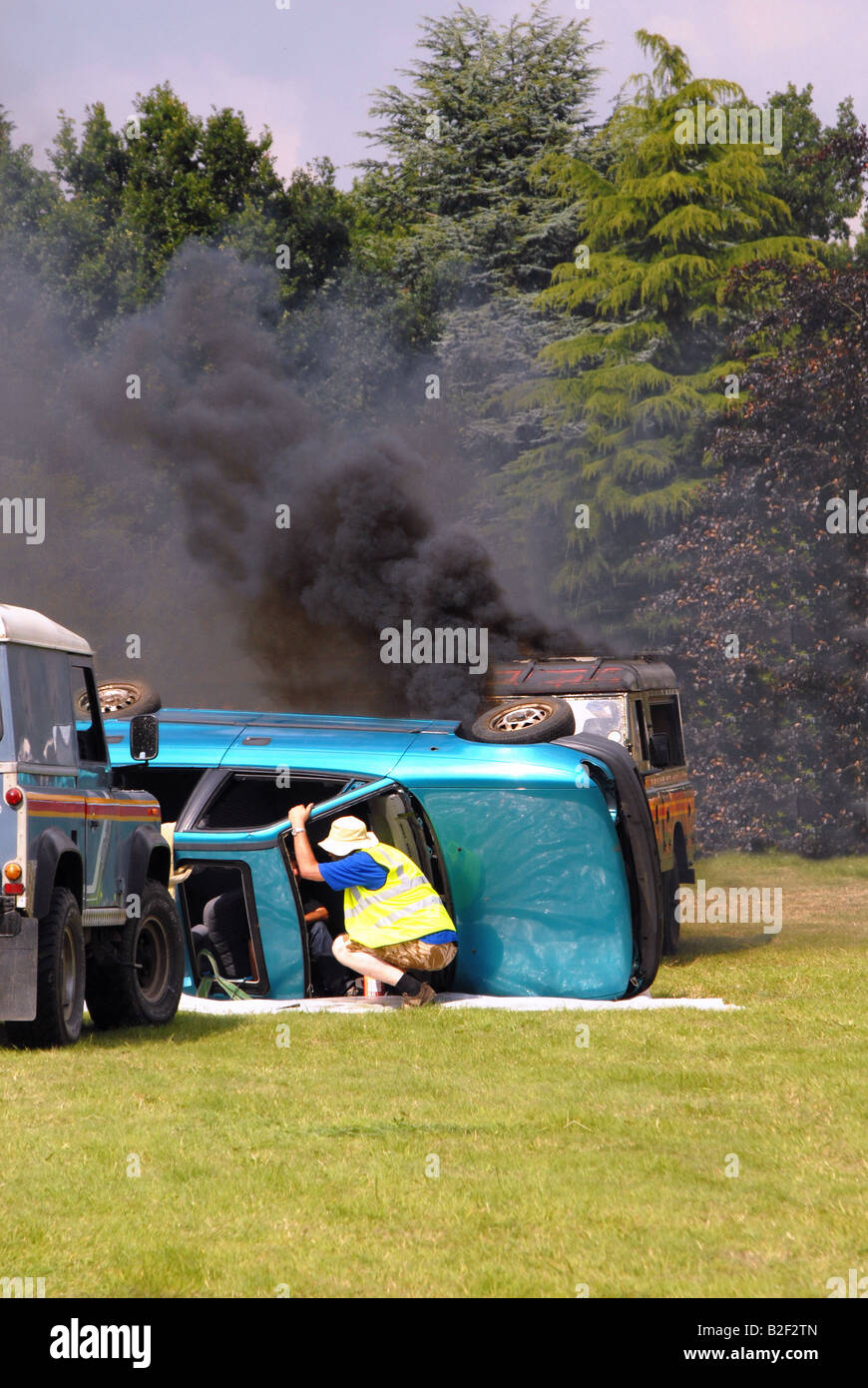 people trying to rescue trapped driver who car is on fire Stock Photo ...