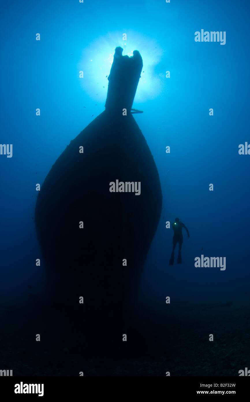 Silhouette of a diver and the wreck of the Mahi off the western side of