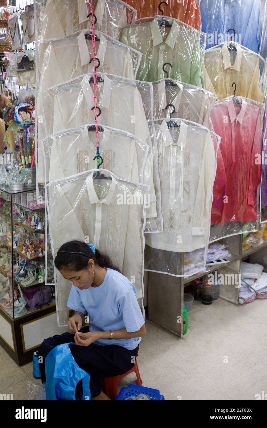 A Filipina works on a barong in her shop in the Divisoria district of Metro Manila, Philippines. Stock Photo