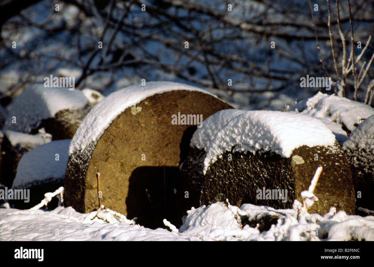 Millstones in the winter snow Peak District National Park Derbyshire Stock Photo