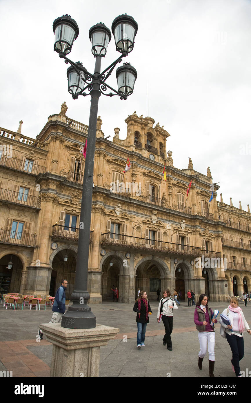 SPAIN Salamanca People walk across Plaza Mayor town hall and colonnade and lampstand Stock Photo
