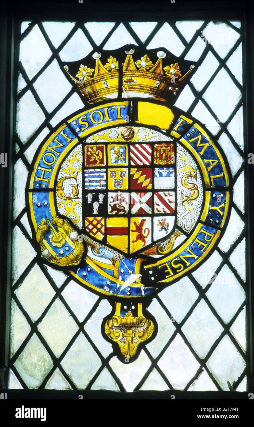 Order of the Garter stained glass Haddon Hall Derbyshire England UK Honi Soit qui mal y pense Latin inscription Tudor art Stock Photo