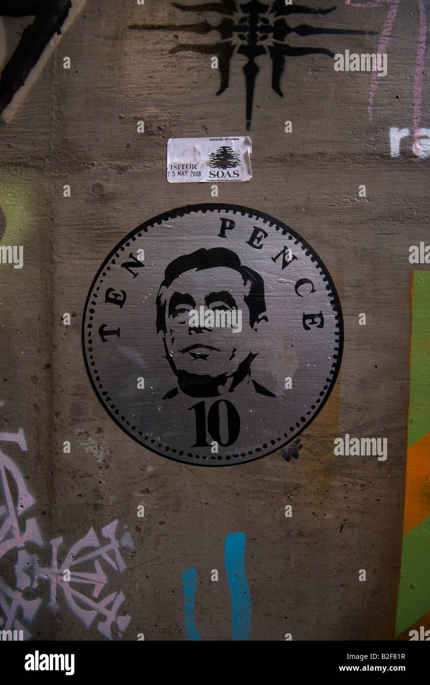 Cans Festival stencil grafitti artwork 10p coin and Gordon Brown on a wall underneath Waterloo train station, London, UK. Stock Photo