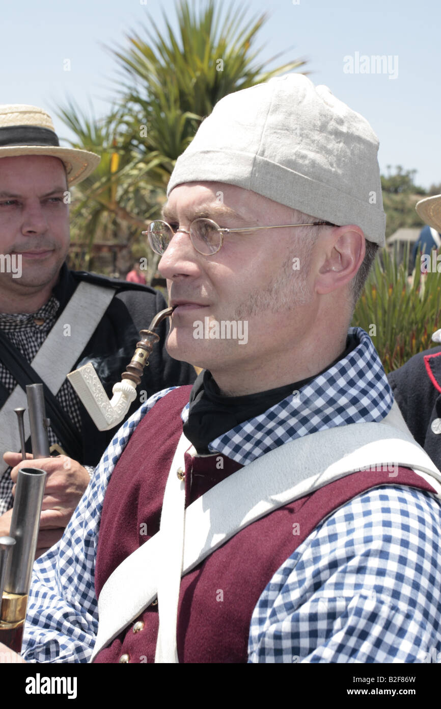 A British Navy sailor played by Simon Allan smoking a clay pipe during a reenactment of the 1797 battle of Santa Cruz, Tenerife Stock Photo