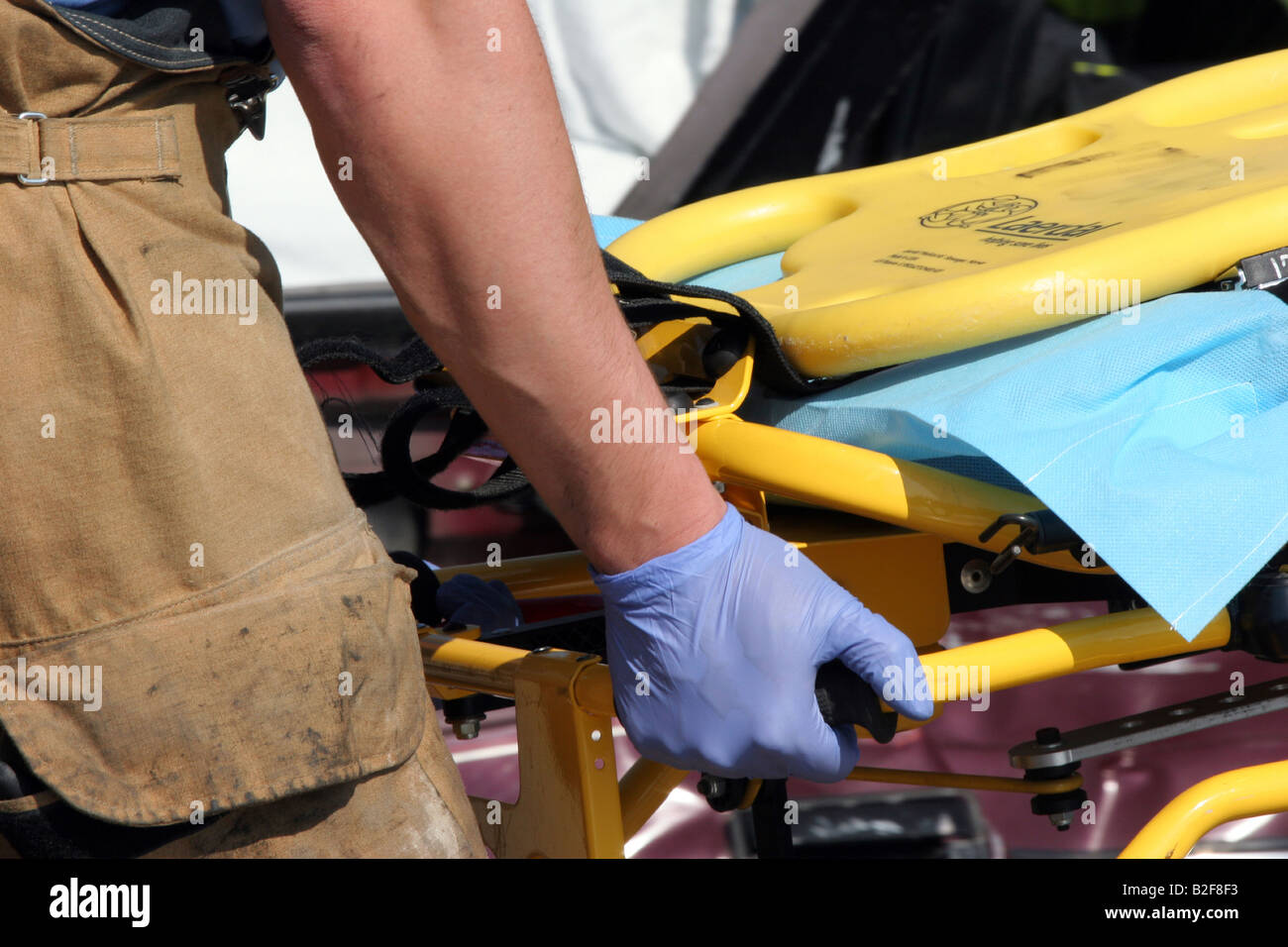 An EMS worker preparing the stetcher for a victim to be loaded after an accident to be transported to the hospital Stock Photo