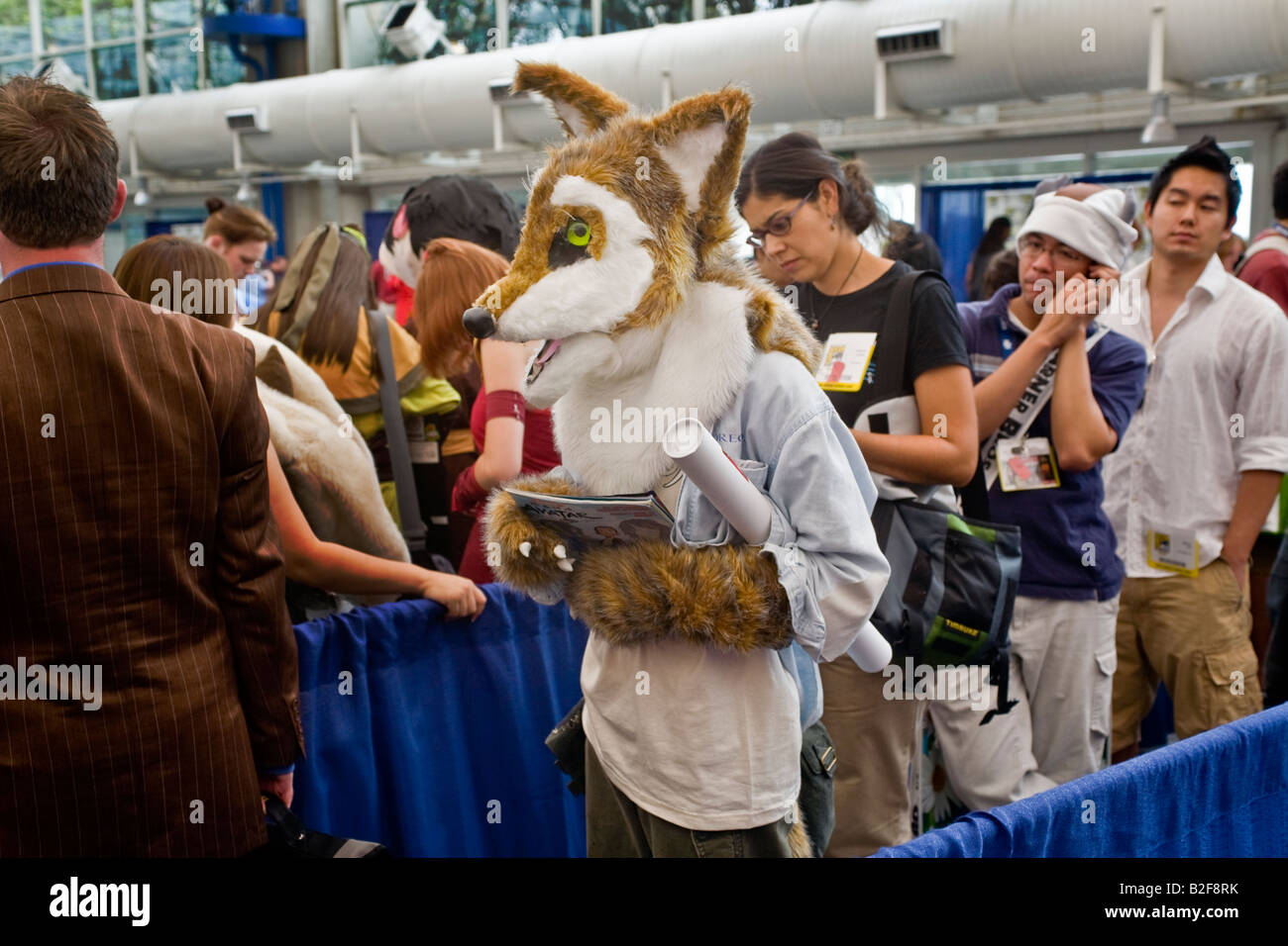 Wearing a fox head a costumed visitor at Comic Con International at the San Diego Convention Center draws an amused glance right Stock Photo