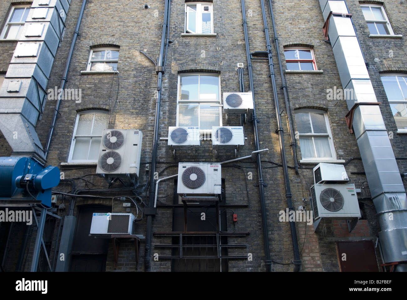 air conditioning units and ducts in a back alley in Soho London Stock