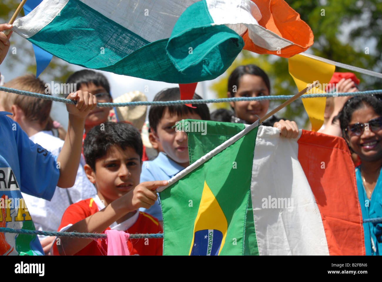 Multinational people and flags celebrate multiculturalism Stock Photo