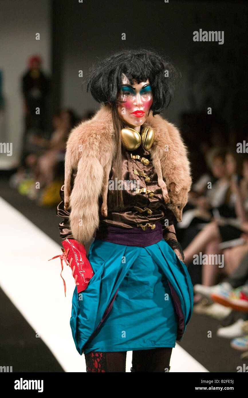 Model on catwalk wearing a mask at Graduate Fashion Week Stock Photo