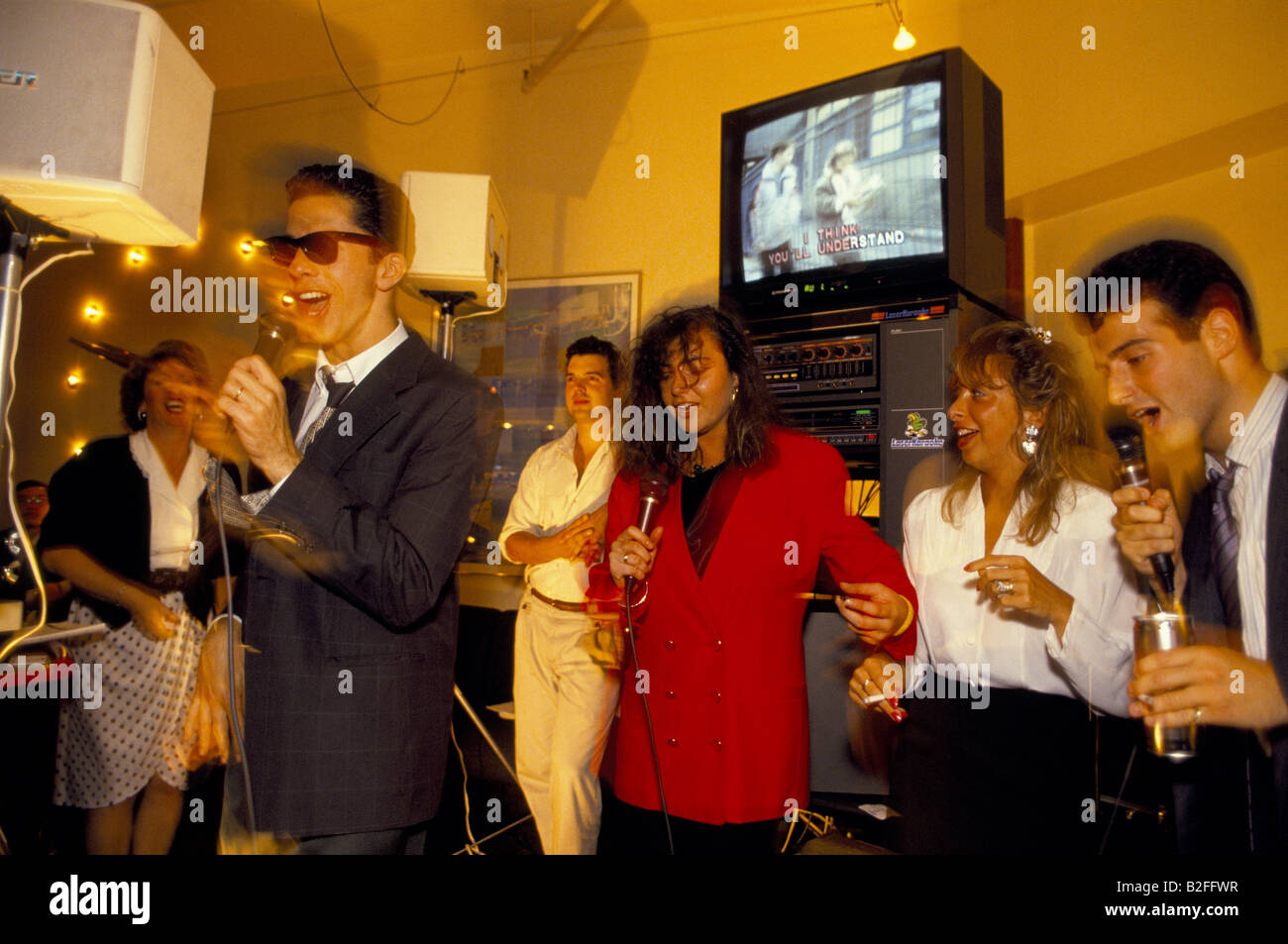 city workers singing karaoke after work coates wine bar city of london, UK Stock Photo Alamy
