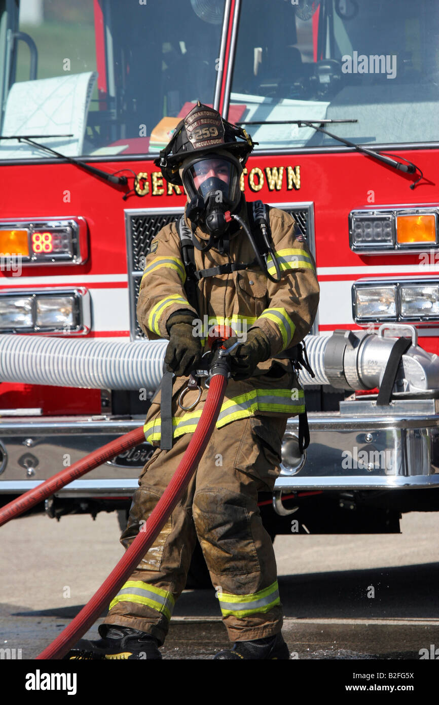 A firefighter pulling hose on a scene in Germantown Wisconsin Stock Photo
