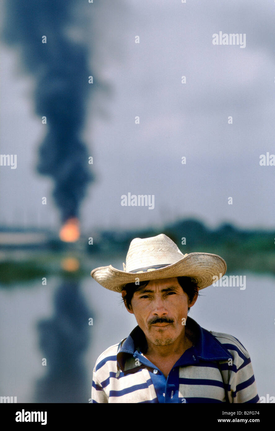portrait of a man standing against oil smoke polluted sky Stock Photo