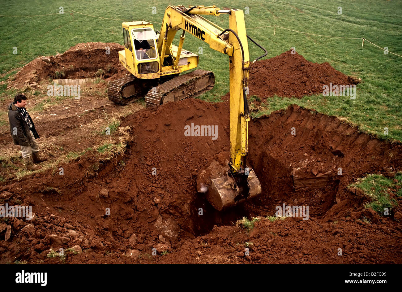 Excavating large hole in field using a mechanical excavator