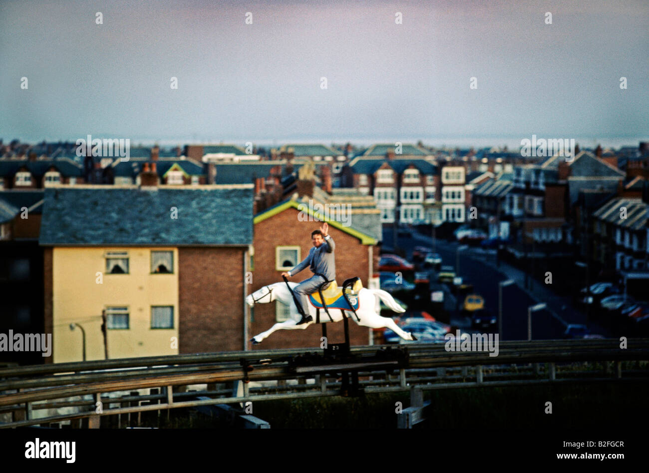 man riding rollercoaster horse blackpool amusement park Stock Photo