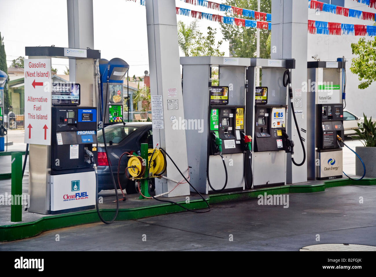 Pumps for propane biodiesel ethanol and natural gas at a San Diego filling station offer an alternative fuel Note sign at left Stock Photo