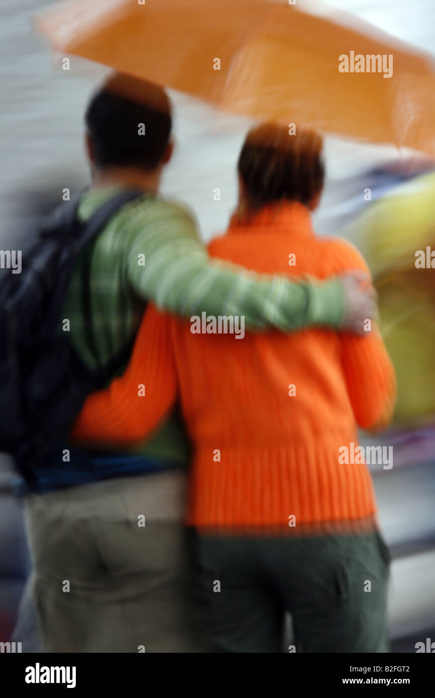 couple sharing an umbrella in rain in town Stock Photo - Alamy