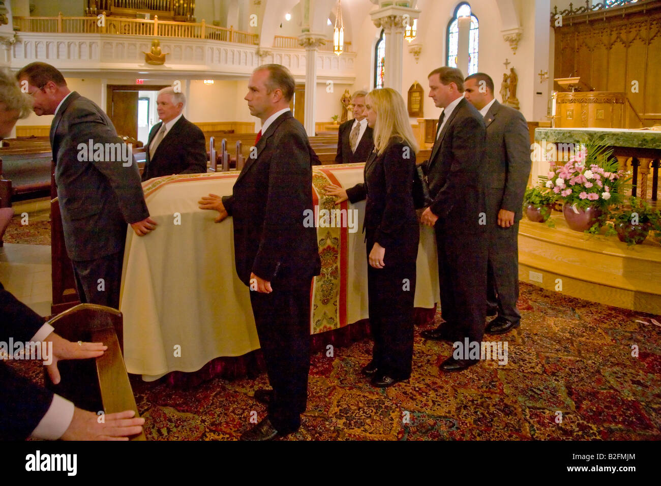 Pallbearers prepare to carry the casket at a Catholic funeral mass in