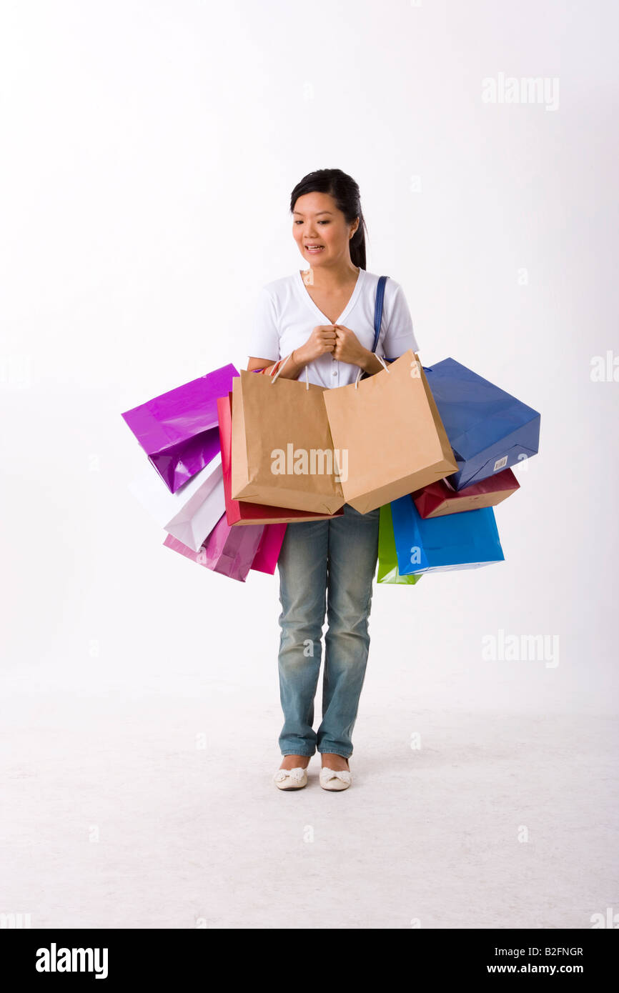 Young woman carrying shopping bags Stock Photo - Alamy