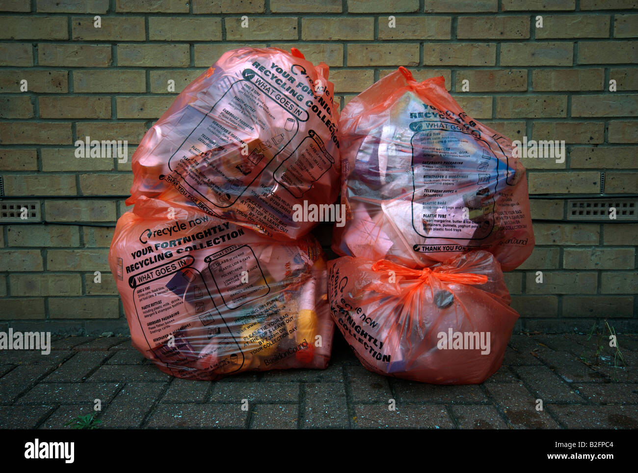 Recycling bags containing rubbish out for collection. Stock Photo
