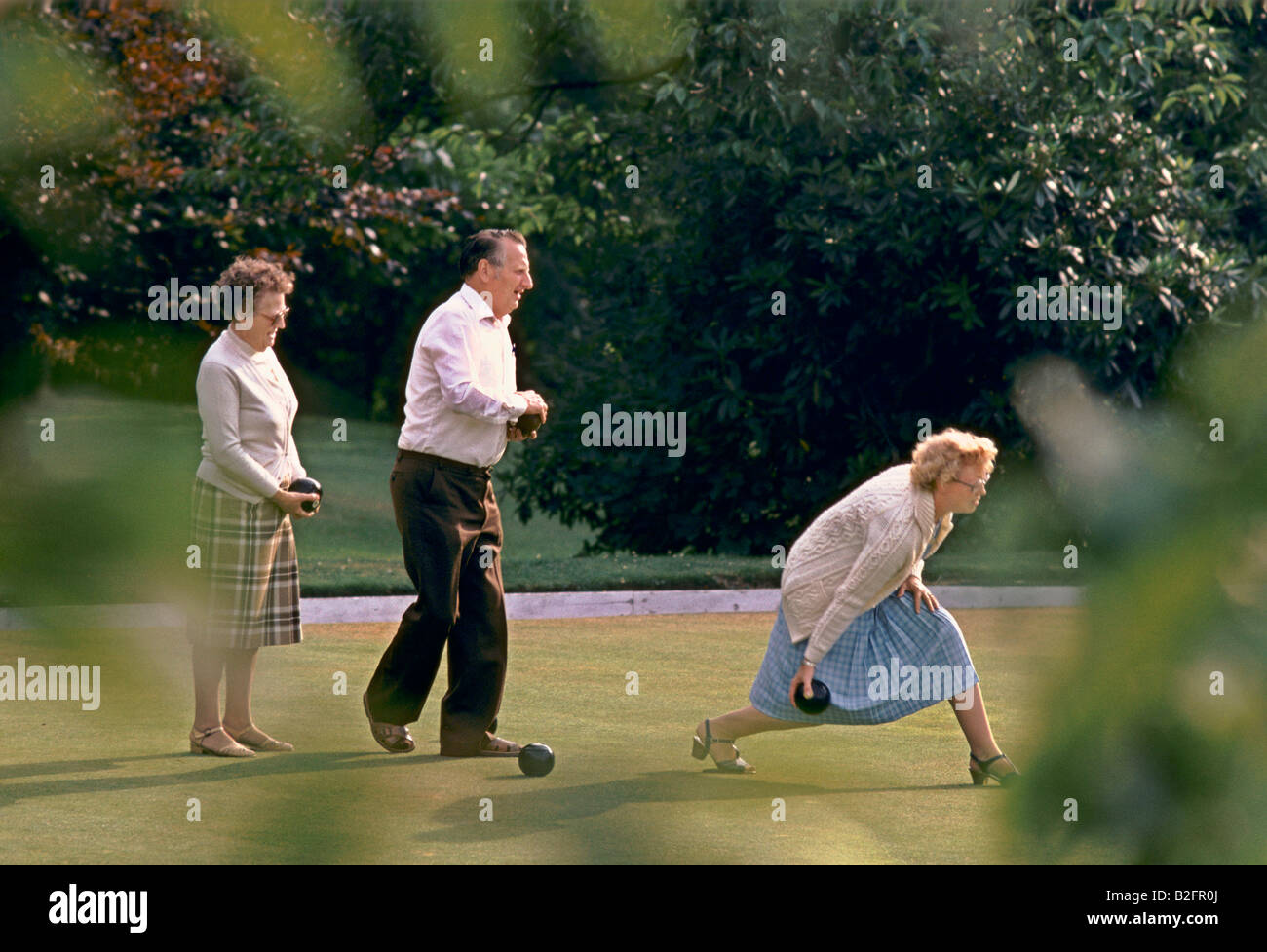 elderly people playing bowls, english country garden Stock Photo