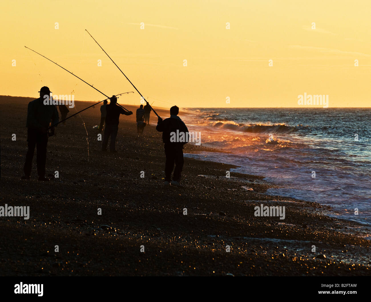Fishing at sunset on Weybourne beach in Norfolk. Stock Photo