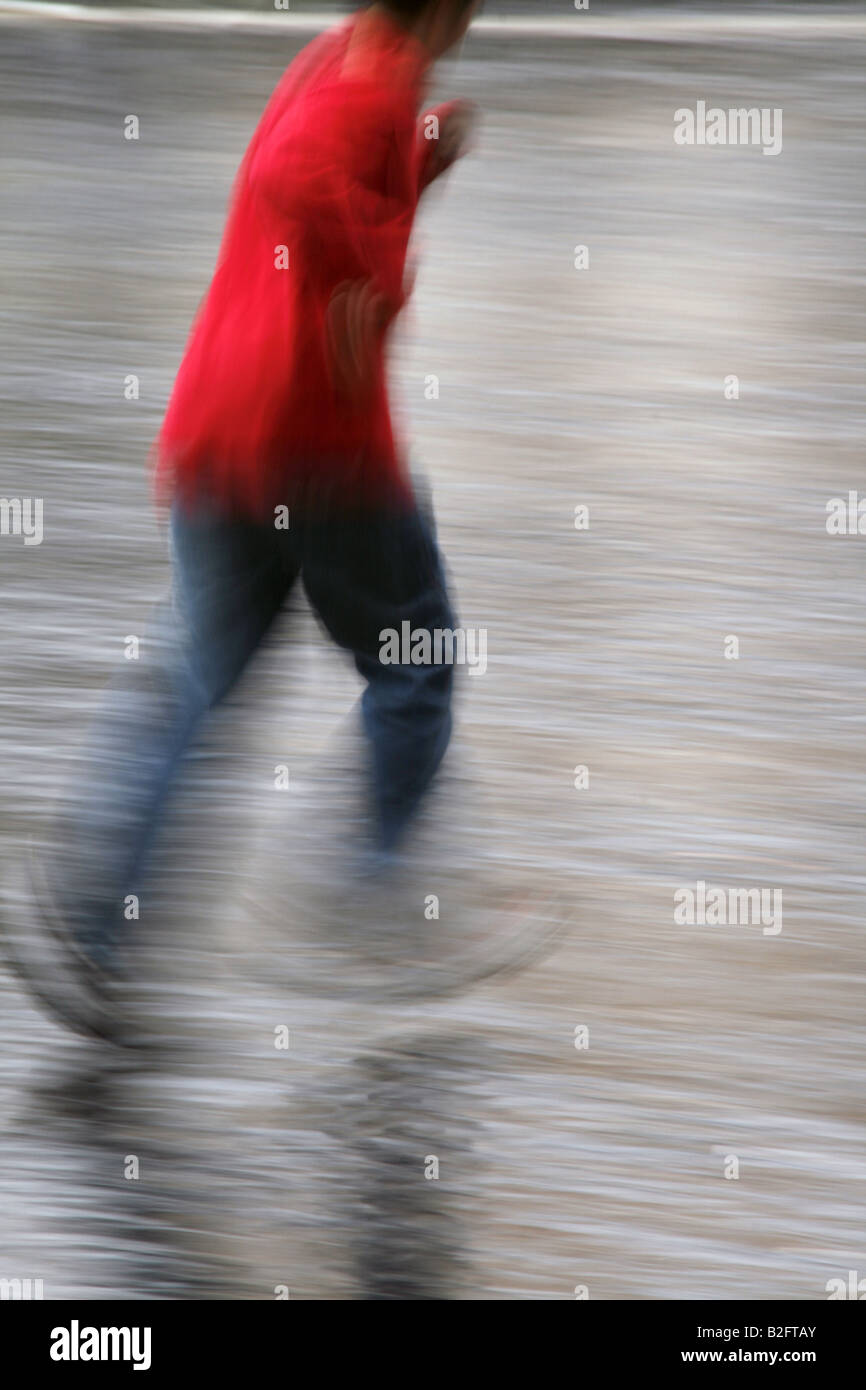 one person running fast in rain in town Stock Photo - Alamy