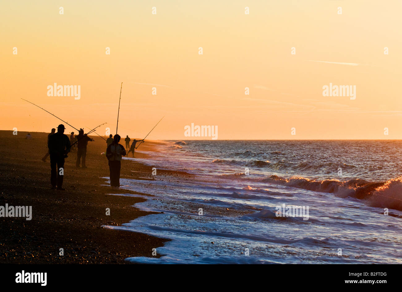 Fishing at sunset on Weybourne beach in Norfolk. Stock Photo