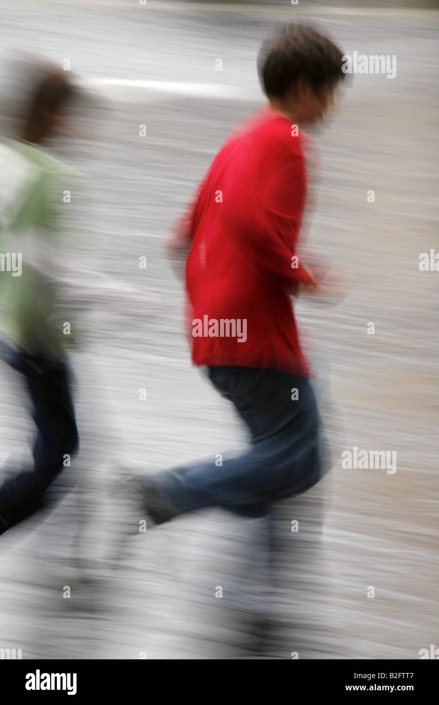 two people running fast in rain in town Stock Photo - Alamy