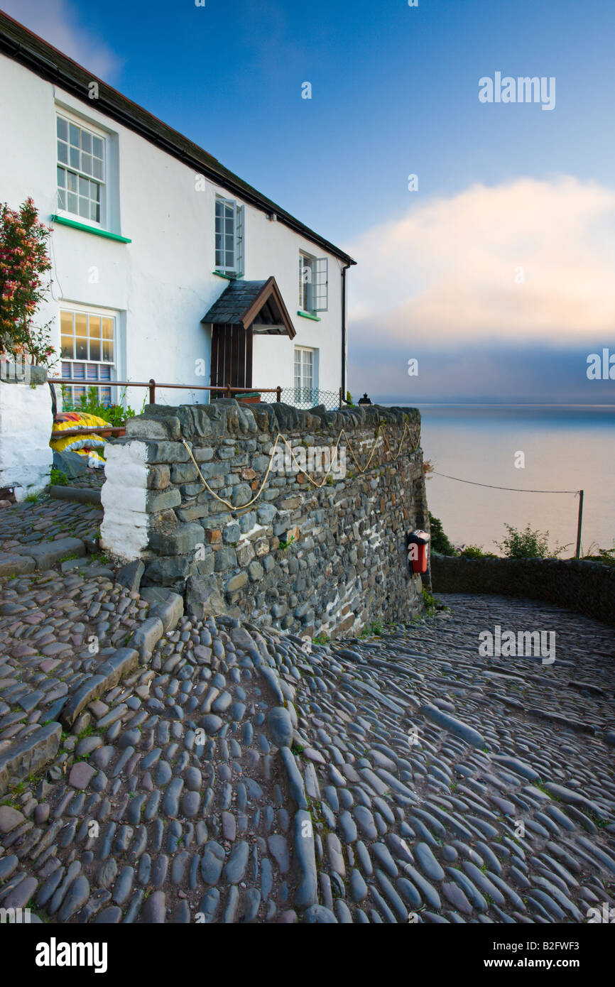 Winding cobbled lane and whitewashed cottage in Clovelly Devon England Stock Photo