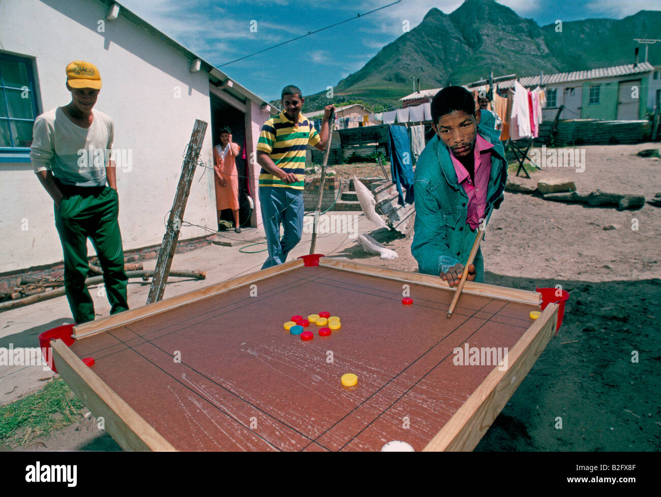 men playing unusual game of billiards at a township in kleinmond south africa Stock Photo