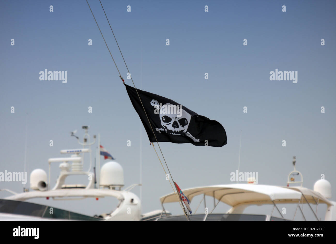 Pirates flag on the modern yacht. Stock Photo