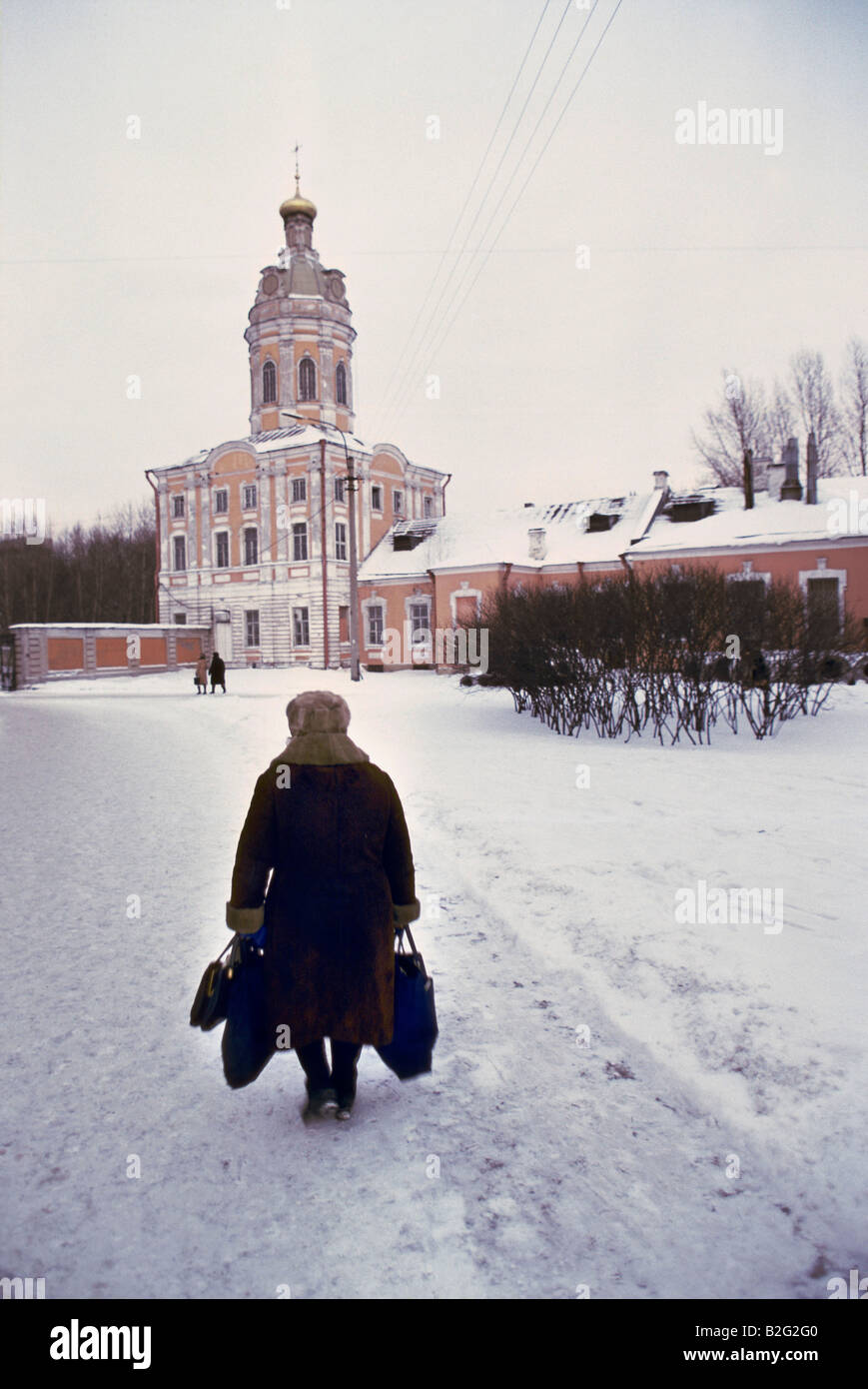 old woman with bags in the snow in st petersburg Stock Photo