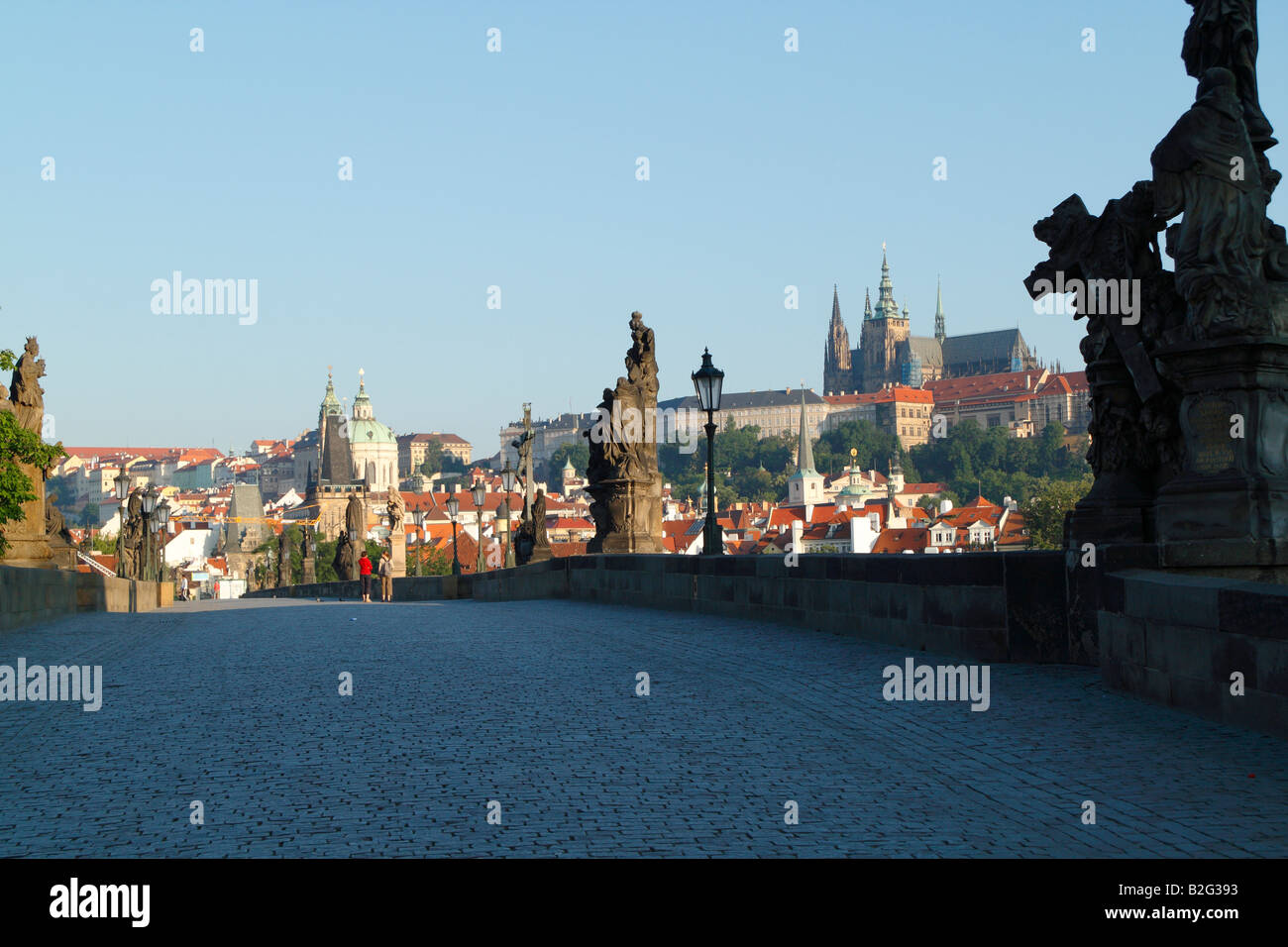 The early morning view of the Charles Bridge with the Hradcany skyline showing St Vitus Cathedral and the Prague castle Stock Photo
