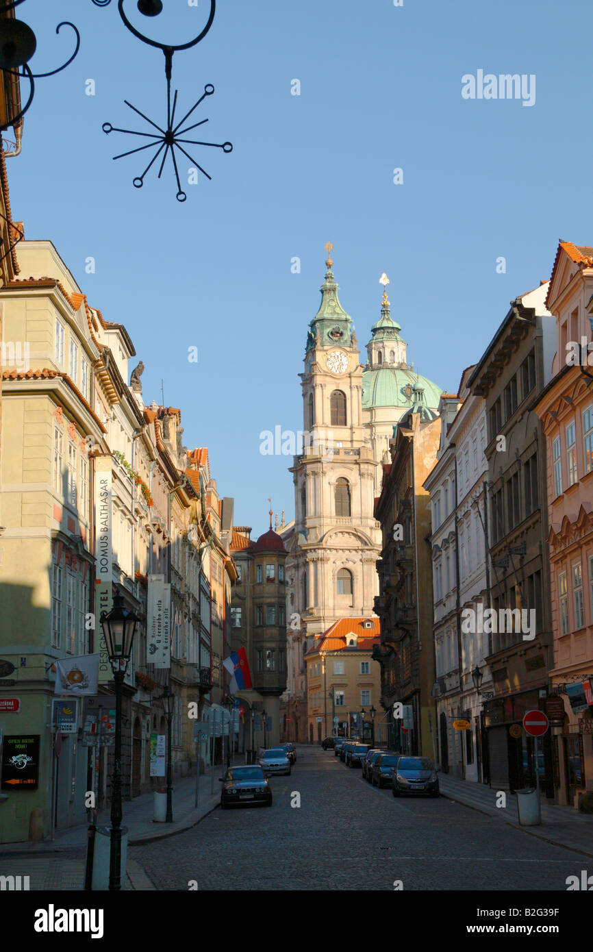 The St Nicolas Dome and Tower seen from Mostecka Street in Prague's Lesser Quarter Stock Photo