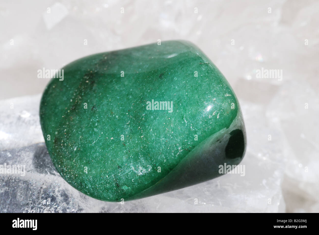 Aventurine green gem energized on druze of quartz crystals Stock Photo