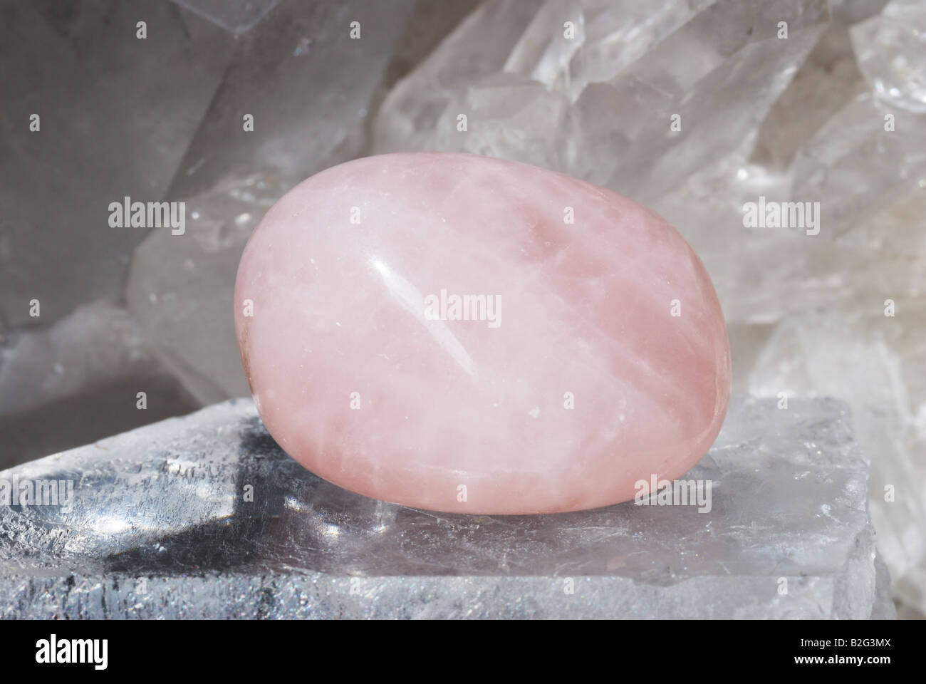 Rose quartz gem energized on druze of quartz crystals Stock Photo