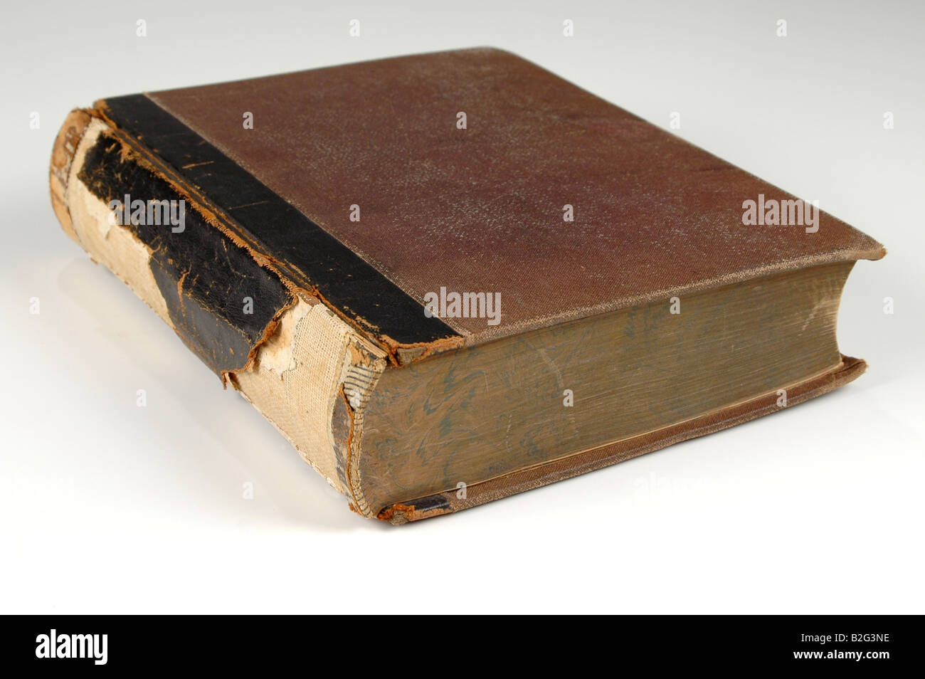 Closed vintage book with torn spine Stock Photo