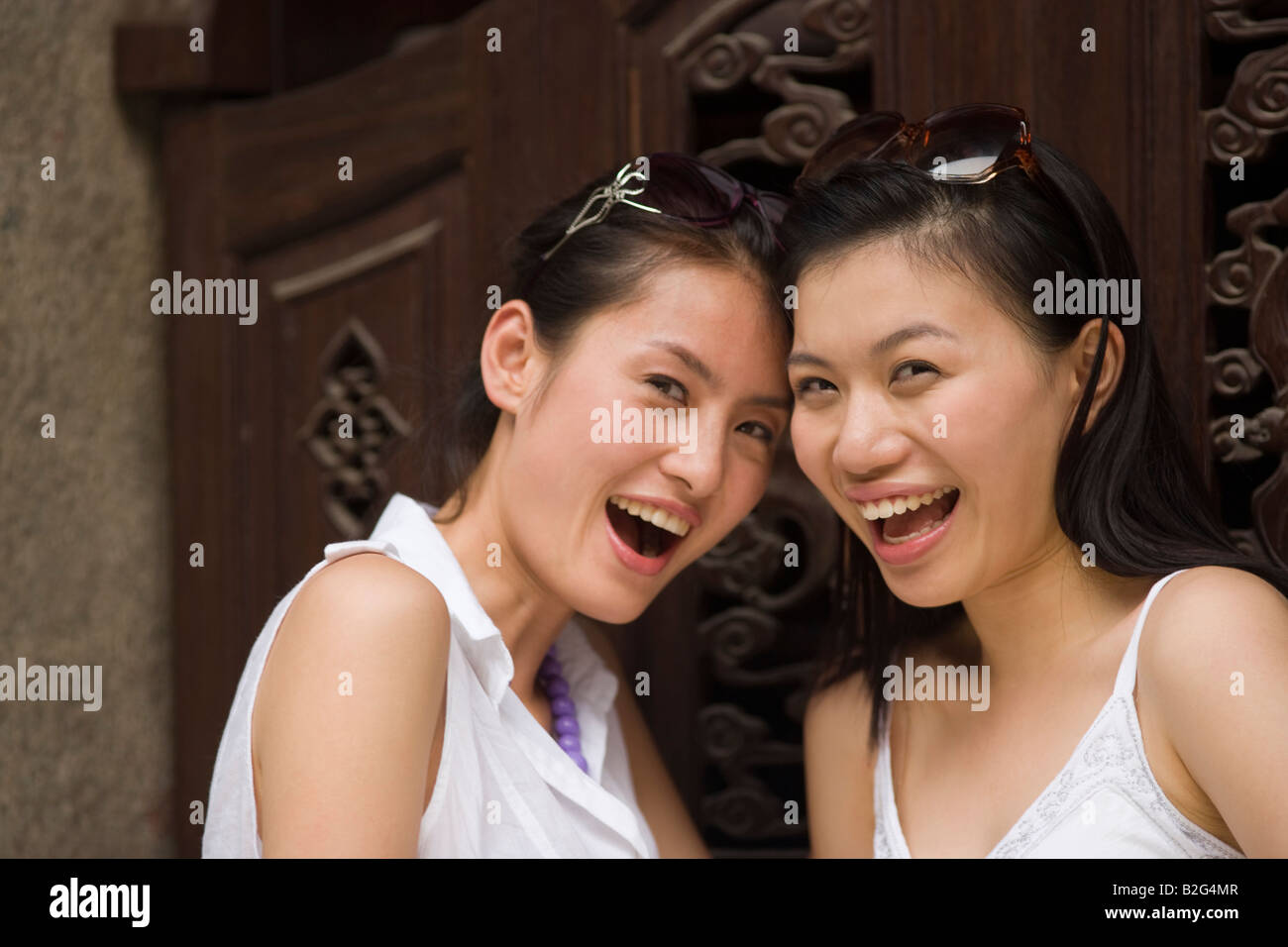 Portrait of two young women laughing Stock Photo - Alamy