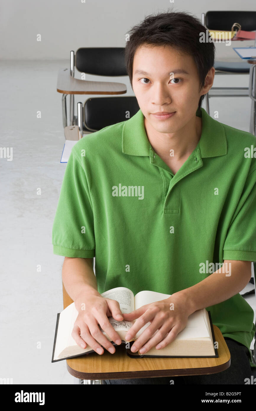Portrait of a young man sitting in the classroom Stock Photo - Alamy