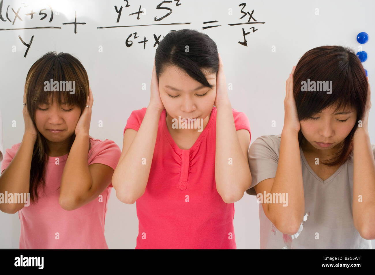 Three young women covering their ears with hands Stock Photo Alamy